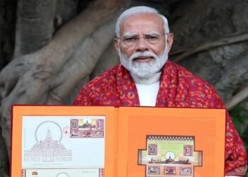 PM Narendra Modi with a book of stamps